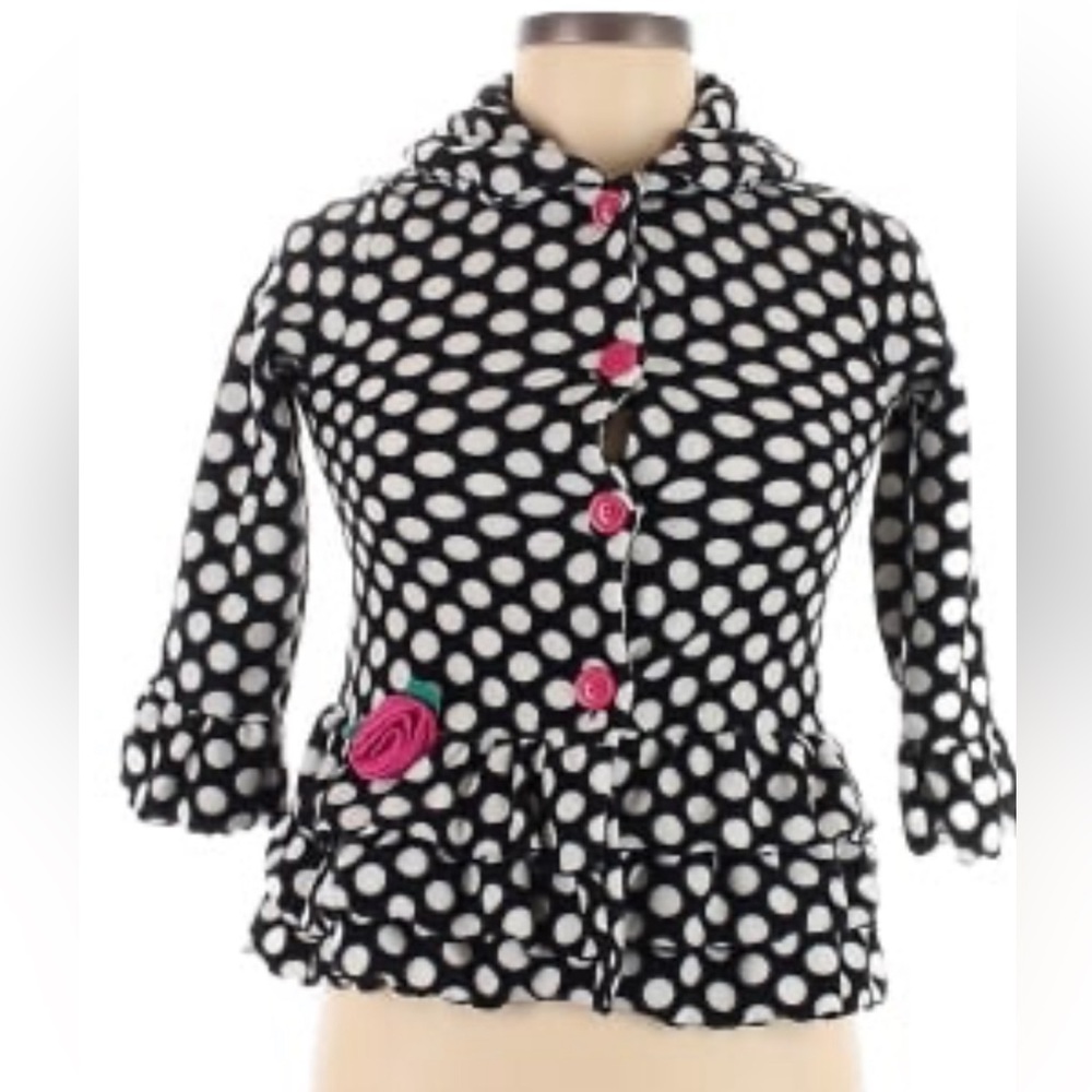 Youth Adorable, black and white fleece jacket with ruffled hem .
